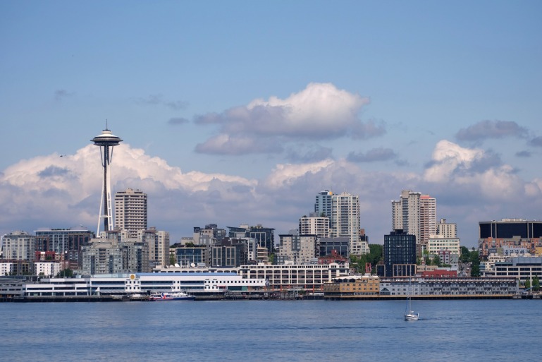 seattle space needle clouds horizon ferry water puget sound cityscape buildings